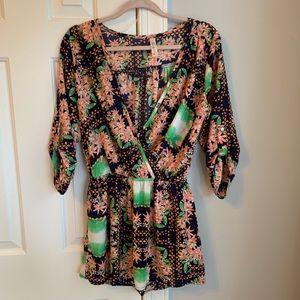 Floral romper with quarter length sleeves. Size M.